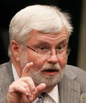 Sen. Jack Latvala, R-Clearwater, left, confers with Sen. Charles Dean, R-Inverness during the questioning period on the redistricting bill during the senate session on Thursday, Feb. 9, 2012, in Tallahassee, Fla. (AP Photo/Steve Cannon)
