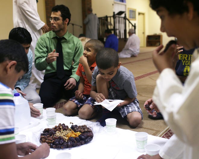 Worshipers break fast with dried dates, fruit and nuts at sunset during Ramadan at the Bay County Islamic Society in Panama City on Thursday.