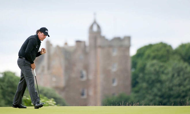 Phil Mickelson reacts to holing a birdie putt on the fourth hole the final round of the Scottish Open on Sunday at Castle Stuart Golf Course in Inverness Scotland. (Kenny Smith/AP)
