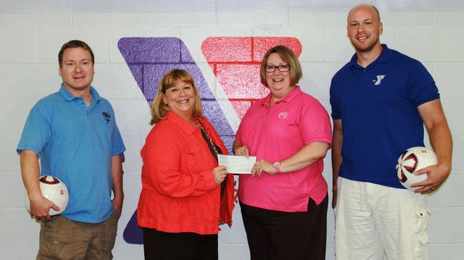 Jayne Cope of McDonald’s (second from right) presents Paula Grigsby (second from left) of the Canton Family YMCA with a grant check for $7,600 for the Y’s soccer program. Looking on are soccer directors Lance Moring and Mark Sawyer.