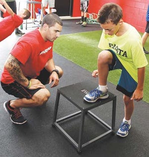 Photo by Tracy Klimek/New Jersey Herald - Joe Martinek, of Hopatcong, shares some tips with 11-year-old Bobby Romano, of Sparta, at Parisi Speed School in Sparta. ‘Jersey Joe’ spent last July and August in Giants’ training camp.