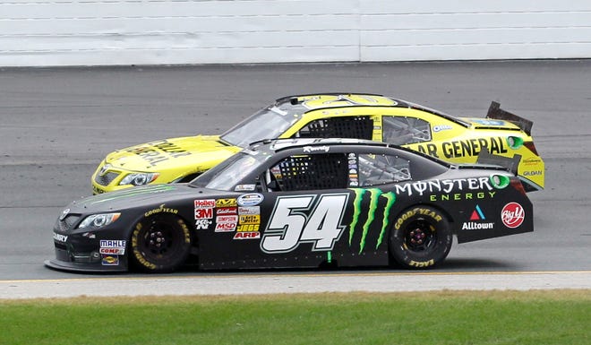 Kyle Busch (54) passes Brian Vickers (20) between Turns 1 and 2 during the NASCAR Nationwide Series auto race, Saturday, July 13, 2013, at New Hampshire Motor Speedway in Loudon, N.H. Busch won the race. (AP Photo/Mary Schwalm)