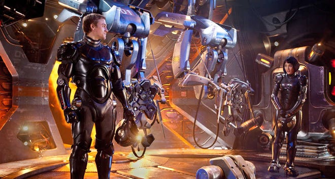 This film image released by Warner Bros. Pictures shows Charlie Hunnam as Raleigh Becket, left, and Rinko Kikuchi as Mako Mori in a scene from "Pacific Rim." (AP Photo/Warner Bros. Pictures, Kerry Hayes)