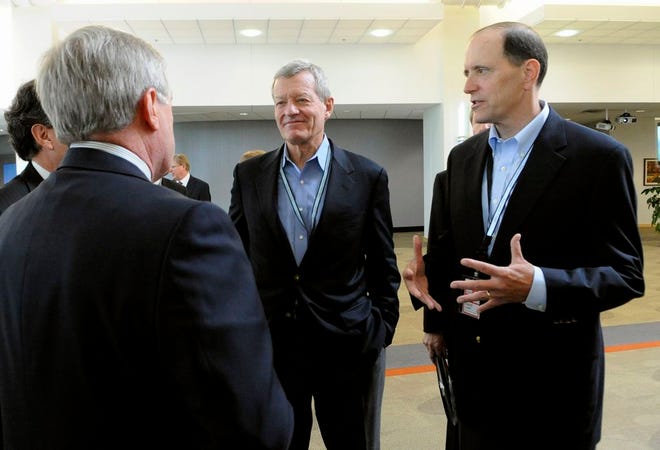 In this July 8 photo, Senate Finance Committee Chairman Sen. Max Baucus, D-Mont., left, and the House Ways and Means Committee Chairman, Rep. Dave Camp, R-Mich., talks about tax reform to 3M's Chief Technology Officer Fred Palensky left, at the 3M Innovation Center in Maplewood, Minn.