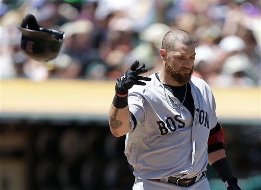 Jonny Gomes tosses his helmet after striking out to Bartolo Colon in the fourth inning of the Red Sox' game against the Athletics Sunday.