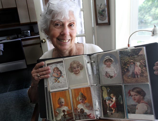 Lynn Gaulin holds an album of old German postcards given to her when she was a little girl.