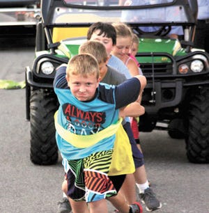 Several teams of various age groups took part in the fire truck pull Friday night as part of White Pigeon Days. Younger teams pulled a Gator, another age group pulled the fire department’s grass trucks, while adults pulled one of the larger trucks.