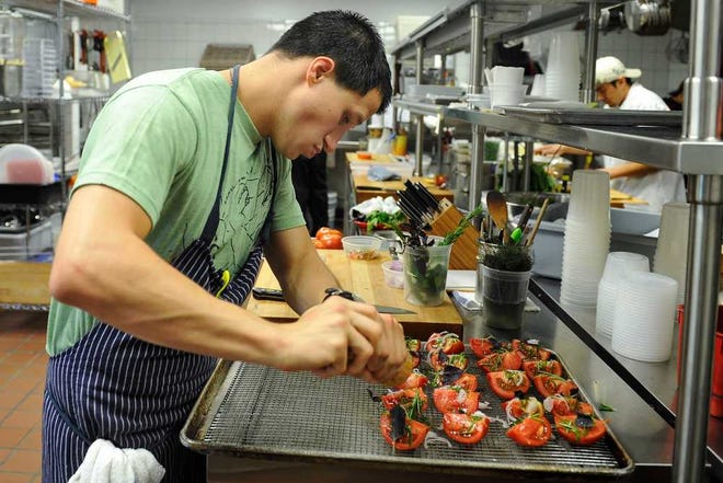 Head chef Kyle Jacovino works in the kitchen of Five & Ten in Athens, Ga., Friday, July 12, 2013. (AJ Reynolds/Staff)