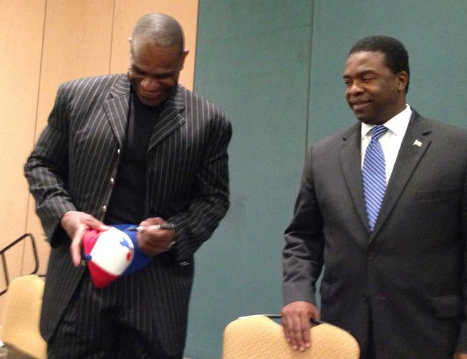 Joe.DeSalvo@jacksonville.com Hall of Famer Andre Dawson, signing a Montreal Expos cap for a fan, gets together with Mayor Alvin Brown at Wednesday's Southern League All-Star Awards Luncheon. Dawson played his first 10 seasons in the majors with the Expos.