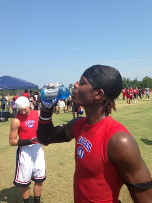 West Craven rising sophomore Danny Harvey drinks a Gatorade during a break at Wednesday’s 7-on-7 event at West Craven Park.