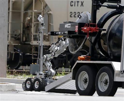 An Atlanta Police robot loads a possible Civil-War era cannonball into an explosives containment vehicle, after it was discovered at a construction site for the College Football Hall of Fame, in Atlanta, Thursday, July 18 2013. The cannonball was taken to a safe area to be further examined and disarmed if needed. (AP Photo/John Bazemore)