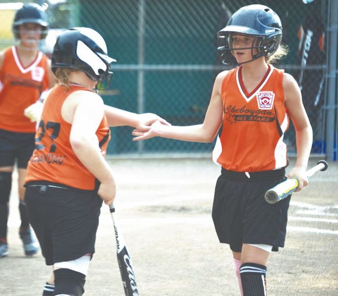 Cheboygan's Angie Swiderek (right) gets congratulated by teammate Morgan Brandau (left) after Swiderek scored in the second inning of a District 13 contest against Tri-Rivers in Indian River on Thursday.