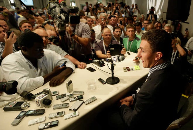 Texas A&M quarterback Johnny Manziel talks with reporters Wednesday during the Southeastern Conference Media Days in Hoover, Ala.
