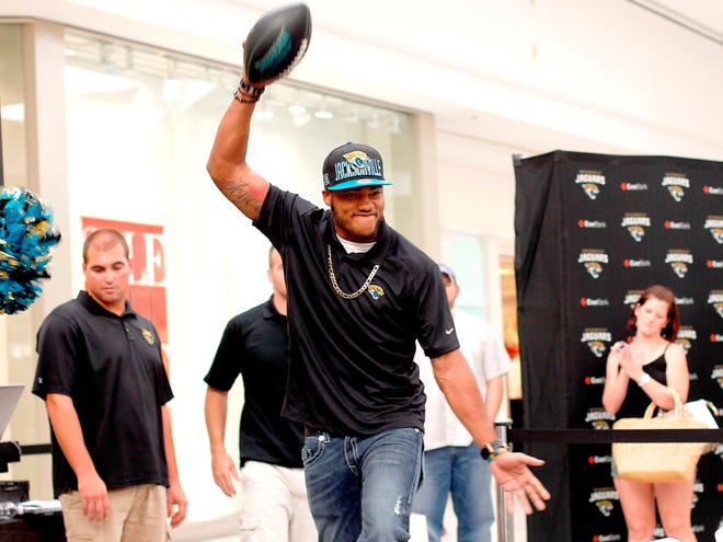 Former Florida Gator Josh Evans does the chomp before speaking to the crowd and signing autographs during the Jacksonville Jaguars Caravan at the Oaks Mall on June 19 in Gainesville. Evans and the Jags agreed to terms Thursday on a rookie contract.