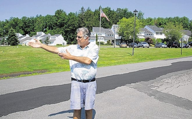 David Love, president of the Inner Circle homeowner's association, stands on Inner Circle Road in Loch Sheldrake Wednesday and talks about plans for a duplex development that would use the road. At least one resident fears a busy road would endanger children.