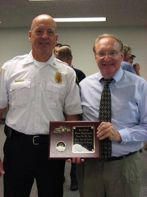 Mayor Jim Gitz presented Fire Chief Kevin Countryman a plaque during a celebration for Countryman's last day as chief July 19.