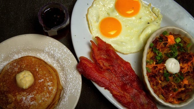 The Standard at Blondies includes two eggs, hash browns, “Beezy Cakes” (special-recipe pancakes), and bacon, and it’s priced at $8.99. (Photo by Libby Volgyes/Special to the Palm Beach Post)