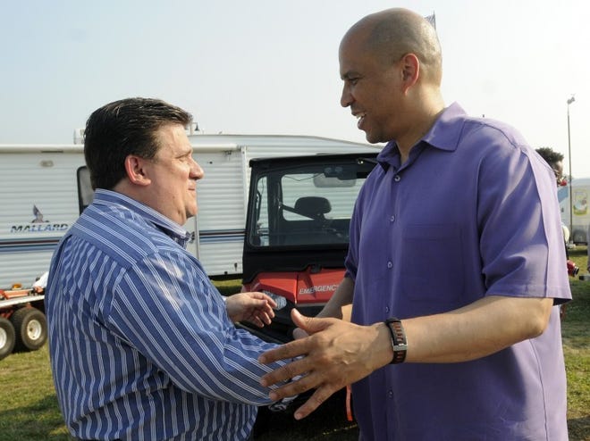 Newark Mayor Cory Booker, the Democratic candidate for the US Senate is greeted by Burlington County chairman Joseph Andl at the Burlington County Farm fair Friday.