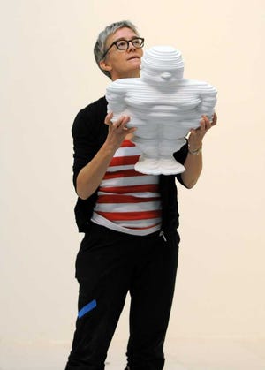 Photos by Bob.Self@jacksonville.com New York artist Heather Cox adjusts the placement of a paper template for the location of one of her "little Crush guys." Eighty-six of the figures are being installed along paths on the walls and floor of the Haskell Atrium Gallery at Museum of Contemporary Art Jacksonville.