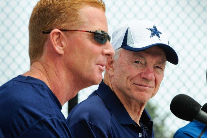 Dallas Cowboys owner Jerry Jones, right, watches as coach Jason Garrett answers a question from members of the media on Saturday in Oxnard, Calif.
