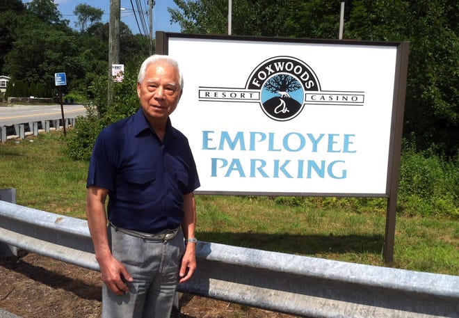 Chinese and American Cultural Improvement Association President John Wong is still working to reestablish a shuttle bus route between Norwich and Foxwoods Resort Casino serving casino employees. Wong is beginning a petition drive among ethnic minorities to short cut the 16 weeks required for state Department of Transportation approval. Wong, who lives in Montville, is pictured here in front of the Route 2 parking lot in Norwich from which Foxwoods shuttled workers for 20 years before ending the service Feb. 29.