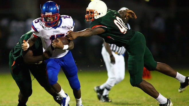 Pahokee High running back Rashaun Croney eludes Atlantic’s Wedley Estime and runs for a first down in a game in August 2012. Croney is one of the players expected to have a breakout season this fall. (Brandon Kruse/The Palm Beach Post)