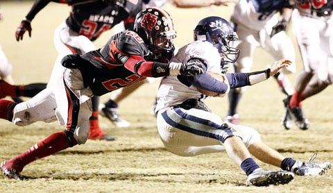 New Bern's Cody Purdie, 20, drags down a Hoggard ball carrier during a game last season. The Bears will no longer be in the same conference as Hoggard. Instead, they will play opponents in Wayne and Pitt County.