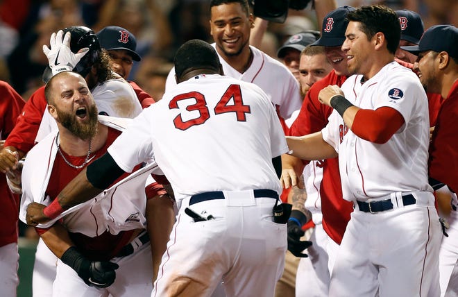 Boston Red Sox's Mike Napoli, left, celebrates his walk-off home run in the 11th inning of a baseball game against the New York Yankees in Boston, early Monday, July 22, 2013. The Red Sox won 8-7. ()