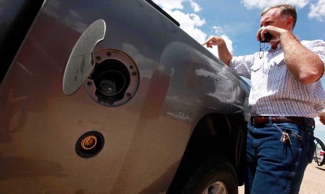 Bill VanHoy explains how his truck runs on both propane and gasoline during a propane workshop at the American Wind Power Center Tuesday. (Stephen Spillman)