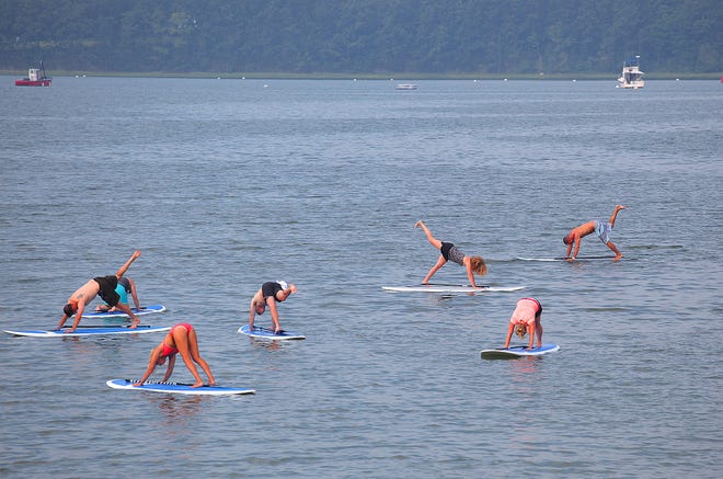 Levitate Surf Shop in Hull provided the stand-up paddleboards for two yoga sessions Saturday, July 20, 2013, at Nantasket Beach, which were sponsored by Lululemon Athletica in Hingham.