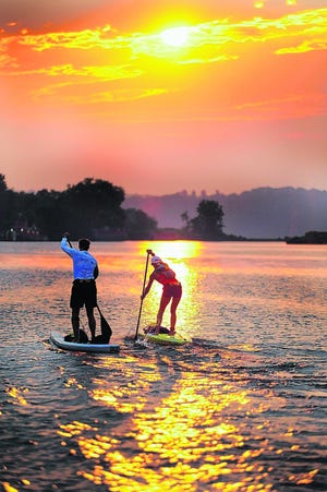 Paddleboarders Frank Carfaro of Manhattan, left, and Karen Wrenn cruise toward the Hudson River on the Rondout Creek at sunrise Saturday during the inaugural 100 Mile Paddle, which began at the Hudson River Maritime Museum at the Rondout waterfront in Kingston.