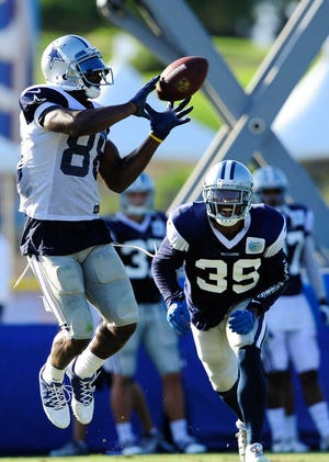 Dallas receiver Dez Bryant, left, gets away from Brandon Carr to make a reception.