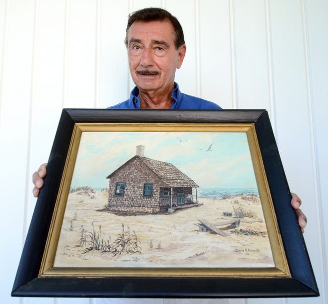 Jim Fusco of Riverside holds one of his oil paintings, titled "Solitude."