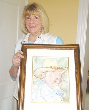Jody Karantonis, a Greencastle native, with a painting of her brother Les Edwards. She created scenes of Greencastle on notecards, which are on sale in town to benefit Allison-Antrim Museum. Some for sale during Old Home Week will also benefit the triennial celebration.