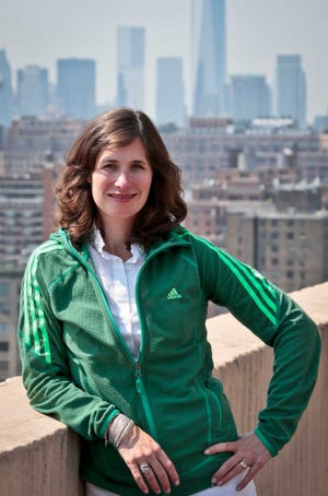 In this Thursday, July 18, 2013 photo, Samantha Critchell, fashion reporter and editor at the Associated Press, poses wearing a technology-infused sports jacket. The jacket is made of breathable wicking fabrics used in the sports market to regulate body temperatures. (AP Photo/Bebeto Matthews)