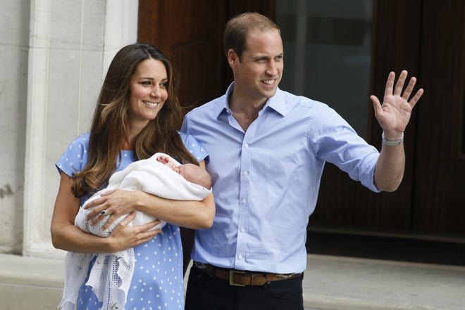 Britain's Prince William, right, and Kate, Duchess of Cambridge, holding her newborn born son Tuesday outside St. Mary's Hospital in London where the Duchess gave birth on Monday.