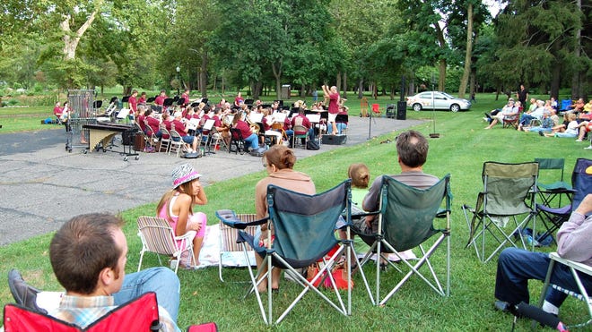 The Hillsdale Wind Symphony, led by director Bob Livingston, entertained a large audience in Mrs. Stock's Park Tuesday night. NANCY HASTINGS PHOTO