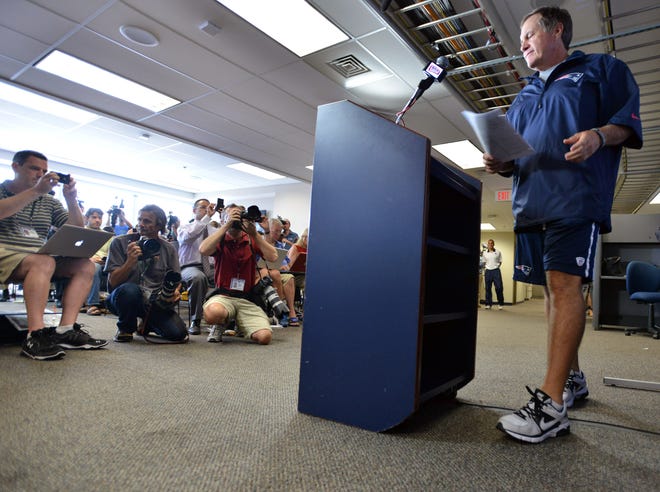 New England Patriots NFL football head coach Bill Belichick arrives to speak to reporters in Foxborough, Mass., Wednesday, July 24, 2013. Belichick broke his silence four weeks after former Patriots tight end Aaron Hernandez was charged with murder. Belichick says the Patriots will learn from "this terrible experience," and that it's time for New England to "move forward." (AP Photo/Josh Reynolds)