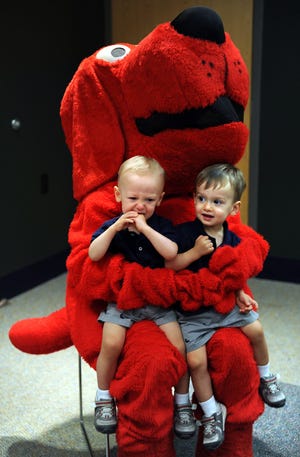 Half of the twenty month old twins Nolan, left, and Liam Falk of Milford were happy to see Clifford.
UFund Start U Reading and Clifford the Big Red Dog visited Milford Public Library Tuesday to get kids into reading. The vent was sponsored by MEFA (the Massachusetts Educational Financing Authority).
Daily News Staff Photo / Allan Jung