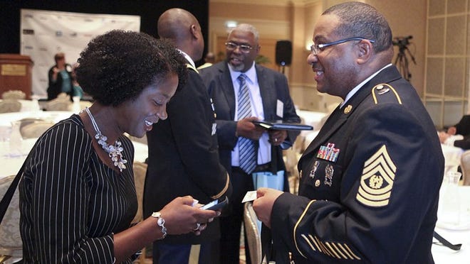Command Sergeant Major Labarry Perine chats with Karen Price-Ward of Southwest Airlines following his speech to members of the National Black Chamber of Commerce on Thursday at the Four Seasons. Perine, who spoke about how the military has prepared him professionally, is the Senior Noncommissioned Officer for Army Recruiting in South Florida. (Damon Higgins/The Palm Beach Post)