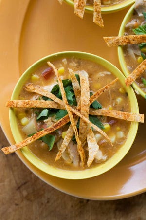Southwestern corn and chicken chowder with tortilla crisps is made with fresh corn. (AP Photo/Matthew Mead)
