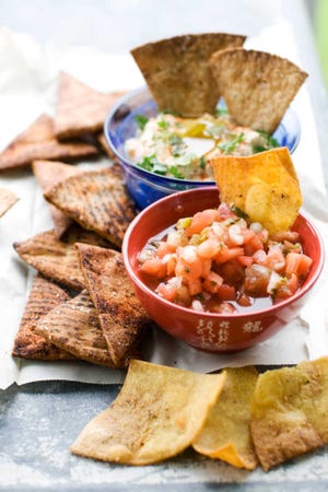 Baked whole wheat pita chips, left, baked whole wheat tortilla chips, top right, and fried tortilla chips with cinnamon sugar can be made in your kitchen. (AP Photo/Matthew Mead)