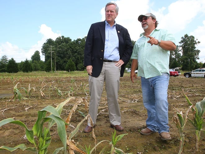 Kirby Johnson discusses the loss of his crop due to an abundant amount of rainfall with Congressman Mark Meadows Friday in Mills River.