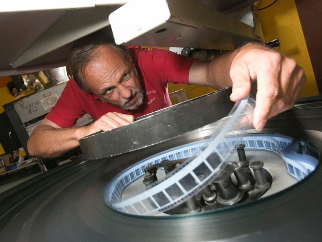 John Watzke, a 3rd generation projectionist, spools up the Ocala Drive In's double feature of "Turbo" and "Wolverine" through the brain and platter Friday afternoon. Car maker Honda has launched an internet vote to fund digital conversion at five drive-ins in the country.