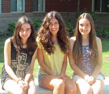 Spanish exchange students Julia Fernandez, 14, Laia Piqueras, 16, and Patricia Perez, 16, take a break from their culture classes at Winnacunnet.