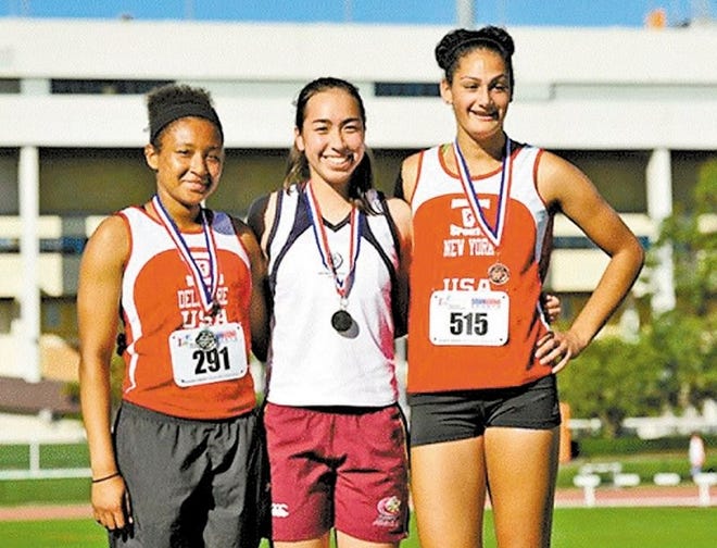 Ciarra Holmes, right, of Plattekill, a senior at Wallkill High School, won a bronze medal in a sports competition in Australia. She is pictured with the winners.