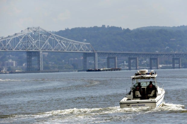 Rescue workers on a boat search the Hudson River on Saturday south of the Tappan Zee Bridge for two people who are believed to have fallen into the water during a boat crash in Piermont, N.Y. A bride-to-be and her fiance's best man were hurled into the river. A woman's body matching the bride-to-be's description was pulled from the river while the search for the man will continue Sunday. Four others were injured after their boat struck a barge under the bridge, according to the Coast Guard.