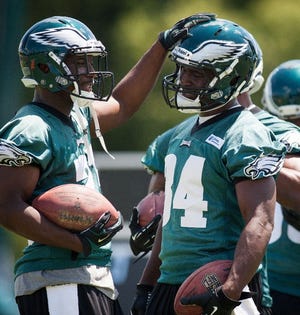 Philadelphia Eagles running back LeSean McCoy, left, pats teammate Bryce Brown on the head during a training camp practice Friday.
