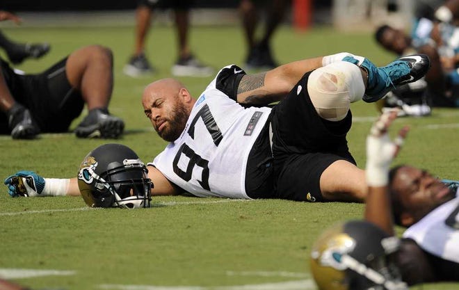 Bob.Self@jacksonville.com The Jaguars' Roy Miller stretches with teammates at the start of Saturday's training camp practice.