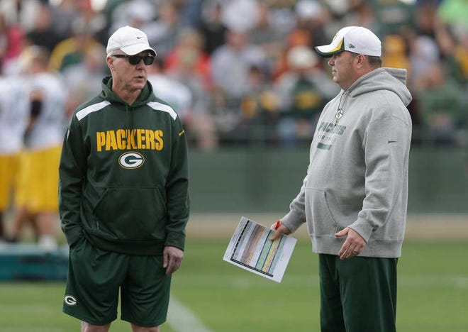 Green Bay Packers head coach Mike McCarthy talks to general manager Ted Thompson, left, during NFL football training camp Saturday, July 27, 2013, in Green Bay, Wis. (AP Photo/Morry Gash)